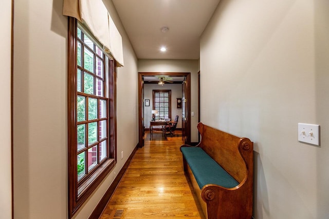 hall with hardwood / wood-style floors