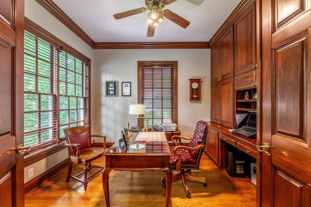 office area with a wealth of natural light, ceiling fan, light hardwood / wood-style floors, and ornamental molding