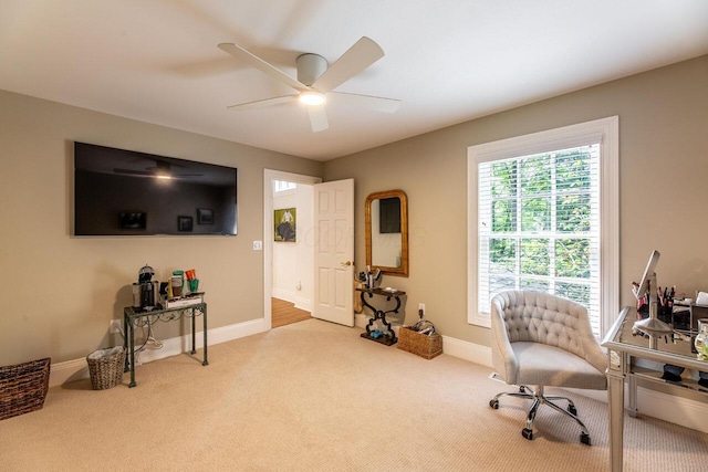 carpeted office featuring ceiling fan