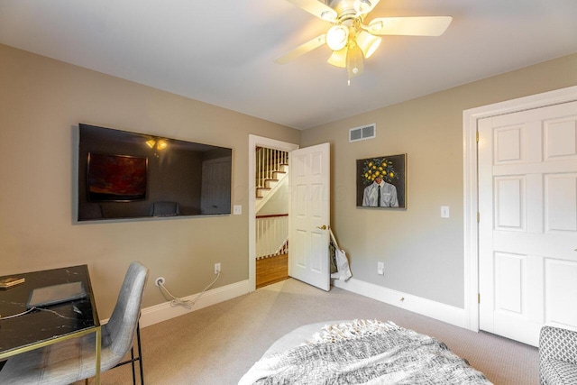 home office featuring ceiling fan and light carpet