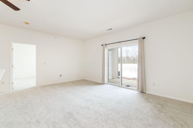 carpeted empty room featuring ceiling fan