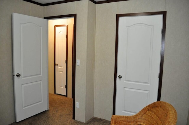 corridor featuring dark carpet and crown molding