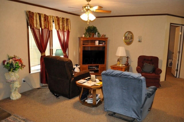 carpeted living room with ceiling fan and ornamental molding