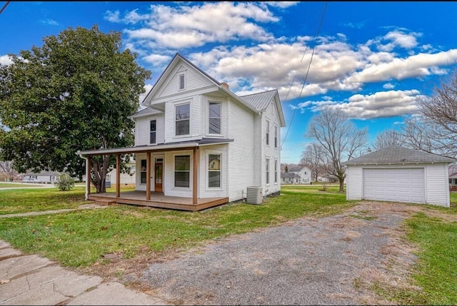 view of front of property with an outbuilding, a porch, a garage, and a front lawn