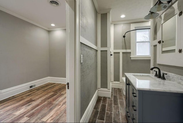 bathroom with crown molding, vanity, and an enclosed shower