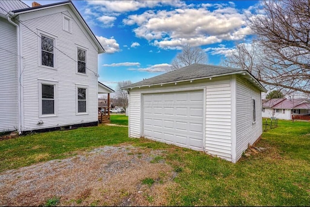 garage featuring a lawn