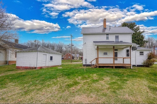 rear view of property featuring a porch and a yard