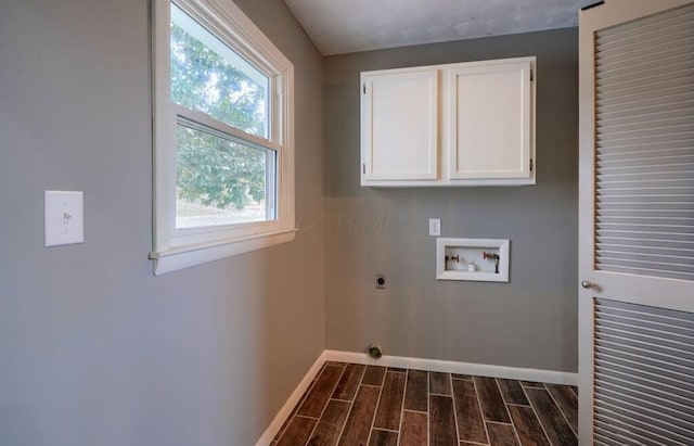 clothes washing area with electric dryer hookup, plenty of natural light, cabinets, and washer hookup