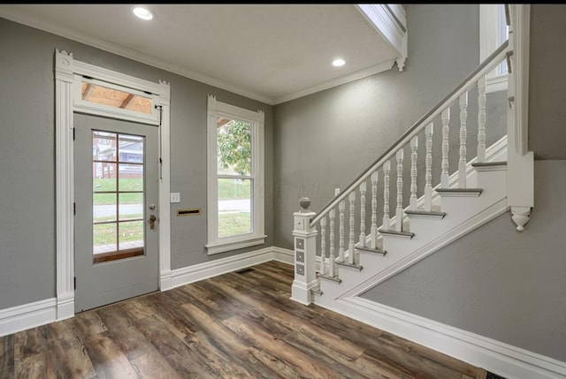 foyer with dark wood-type flooring and ornamental molding