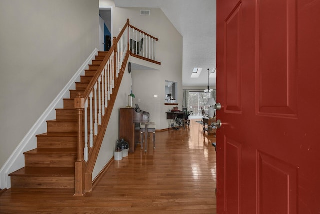 entryway with a chandelier and hardwood / wood-style flooring