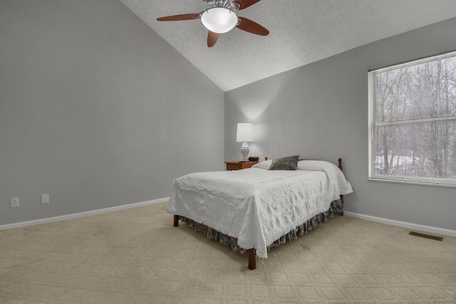 bedroom with a textured ceiling, light colored carpet, ceiling fan, multiple windows, and lofted ceiling