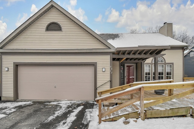 view of front facade with a garage and a deck