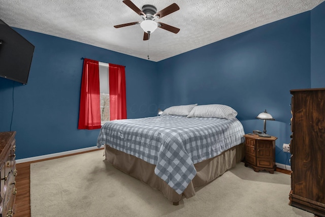 bedroom with a textured ceiling and ceiling fan