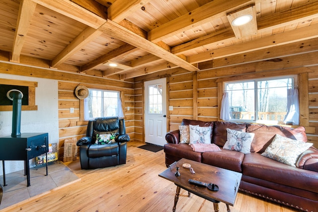 living room featuring beamed ceiling, light hardwood / wood-style flooring, plenty of natural light, and wood ceiling