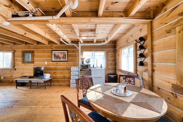 dining room featuring beamed ceiling, plenty of natural light, and wooden ceiling