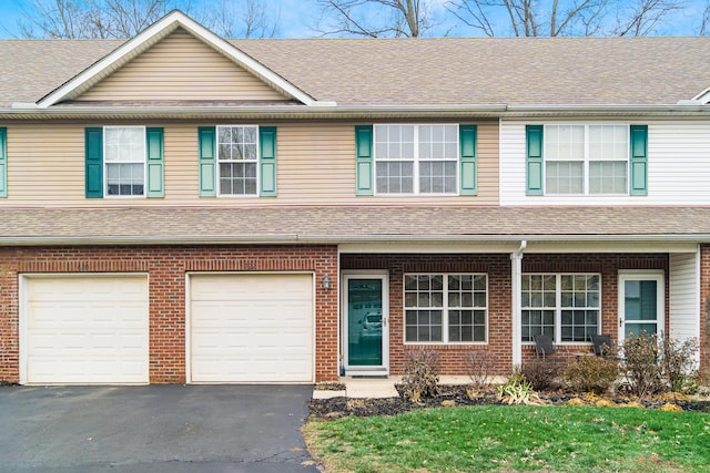 multi unit property featuring a garage