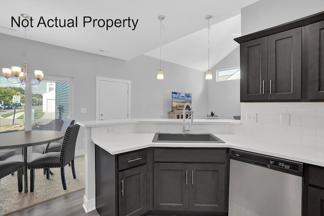 kitchen with stainless steel dishwasher, sink, a wealth of natural light, and an inviting chandelier