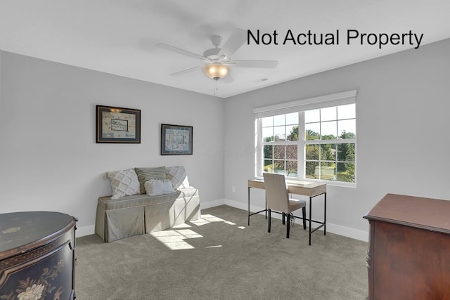 carpeted office space featuring ceiling fan