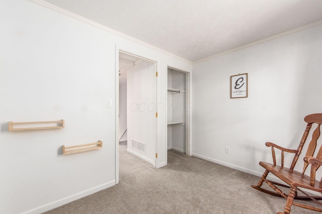 unfurnished room with light carpet, a textured ceiling, and ornamental molding