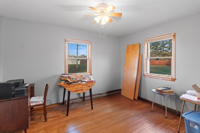 office area with ceiling fan, a wealth of natural light, and light hardwood / wood-style flooring