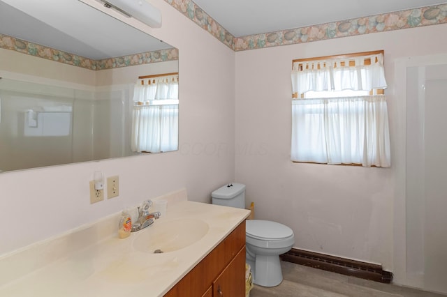 bathroom with hardwood / wood-style flooring, vanity, toilet, and a baseboard heating unit