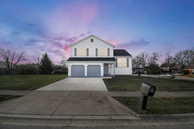 view of front property with a garage and a yard