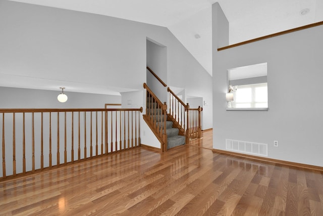 empty room featuring vaulted ceiling and light wood-type flooring