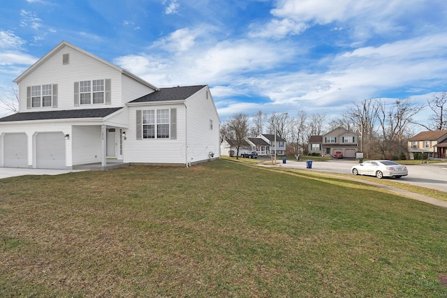 view of front of house featuring a front yard and a garage