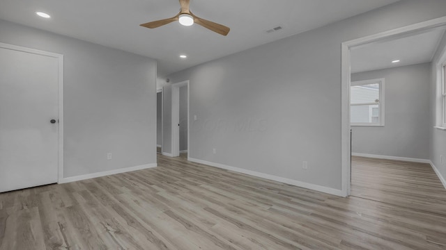 empty room featuring ceiling fan and light hardwood / wood-style floors