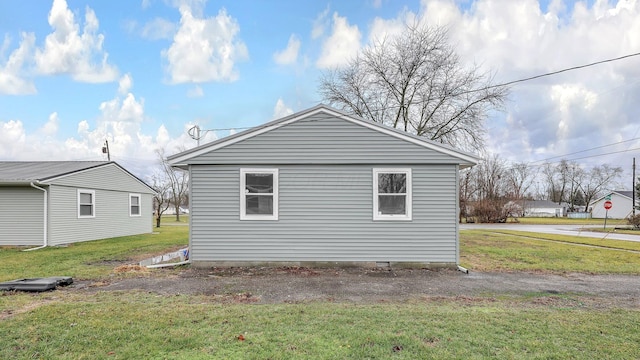 view of side of home featuring a yard