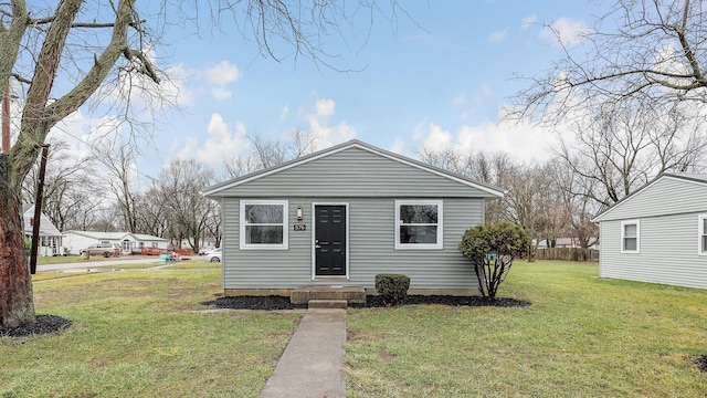 bungalow-style home featuring a front yard