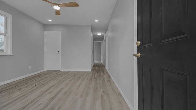 unfurnished room with light wood-type flooring and ceiling fan