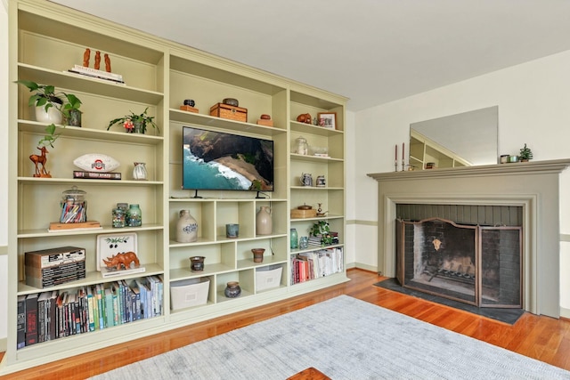 sitting room with light hardwood / wood-style floors and a fireplace