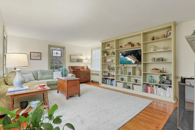 living room featuring radiator heating unit and light hardwood / wood-style flooring