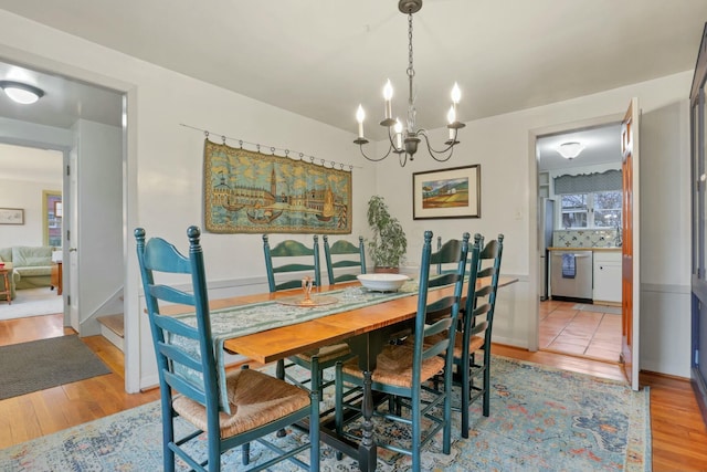 dining room featuring light hardwood / wood-style floors and a notable chandelier