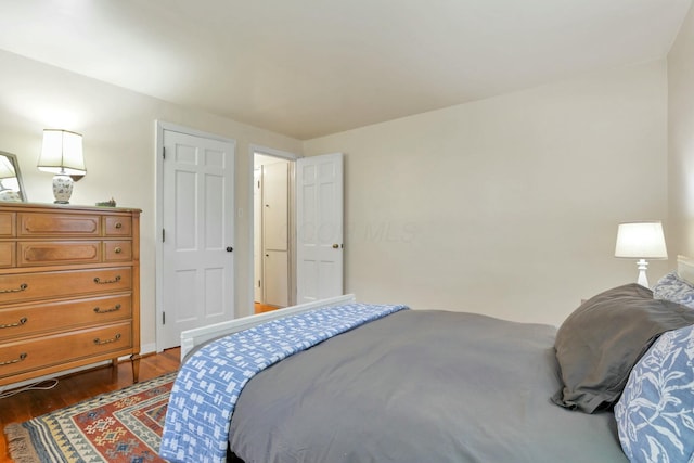 bedroom featuring dark hardwood / wood-style flooring