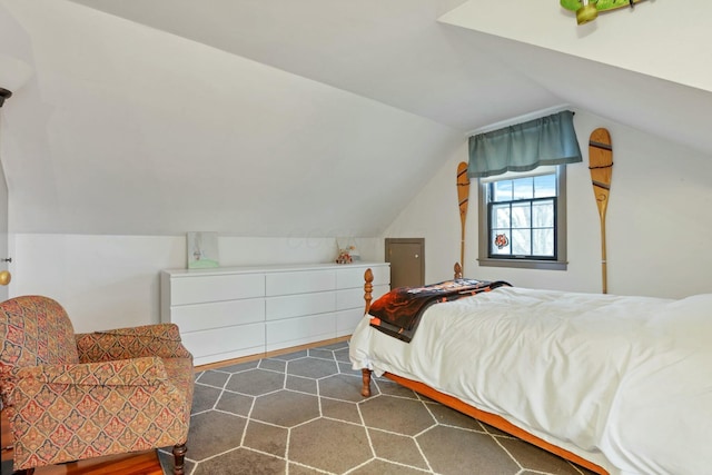 bedroom featuring lofted ceiling and dark wood-type flooring