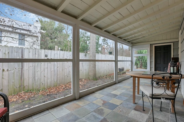 sunroom / solarium featuring wood ceiling, a wealth of natural light, and lofted ceiling with beams