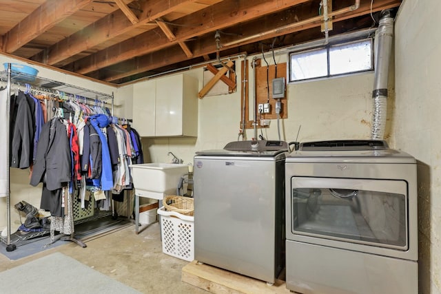 washroom with independent washer and dryer and sink