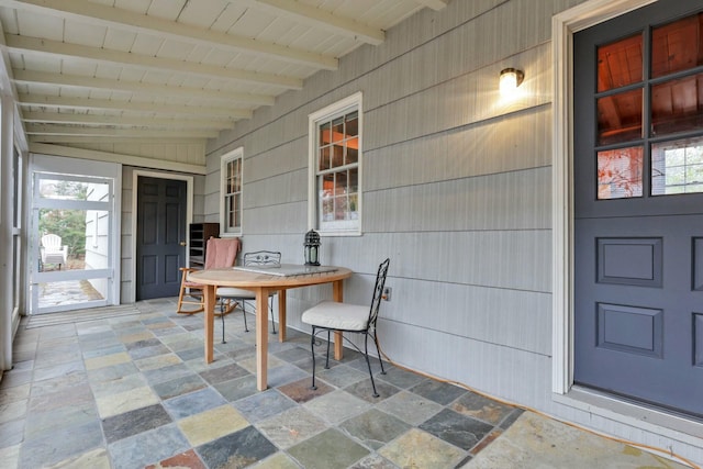 sunroom featuring vaulted ceiling with beams and wood ceiling