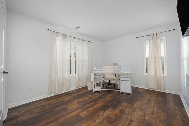 unfurnished office featuring a textured ceiling and dark wood-type flooring