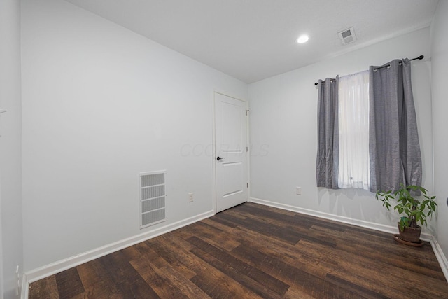 empty room featuring dark hardwood / wood-style floors