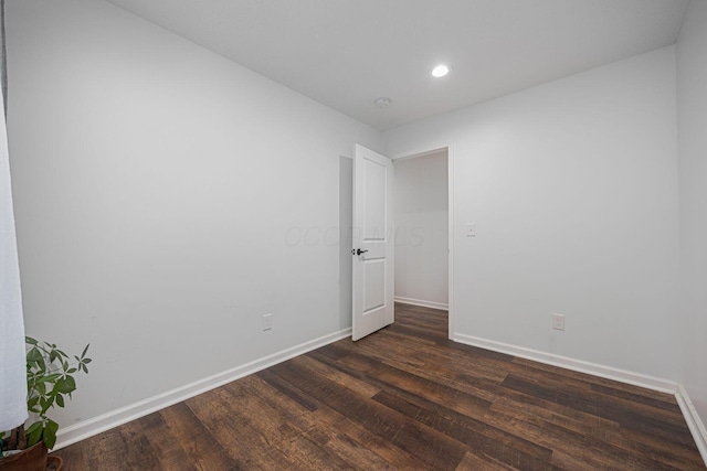 spare room featuring dark hardwood / wood-style flooring