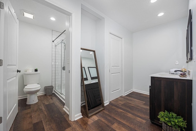 bathroom featuring hardwood / wood-style floors, vanity, toilet, and an enclosed shower