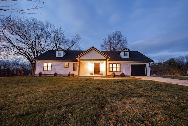 view of front of home featuring a garage and a yard