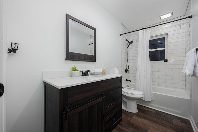 full bathroom featuring wood-type flooring, vanity, shower / tub combo, and toilet