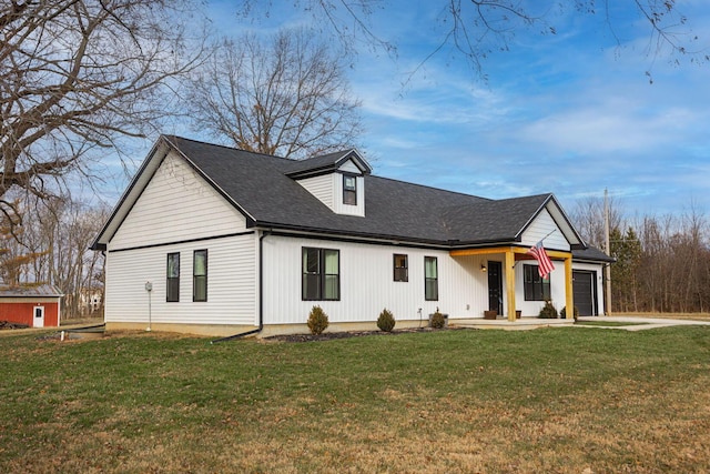 modern inspired farmhouse with a front yard, a porch, and a garage