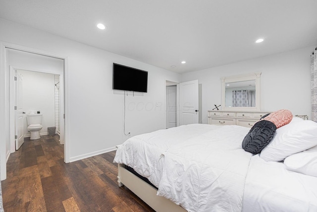 bedroom featuring dark hardwood / wood-style flooring and connected bathroom