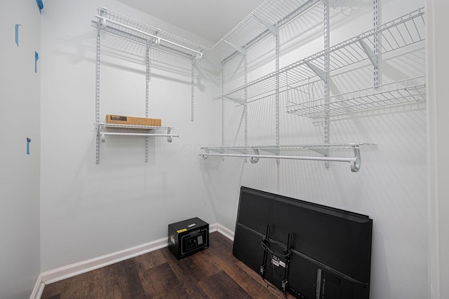 spacious closet featuring dark hardwood / wood-style flooring