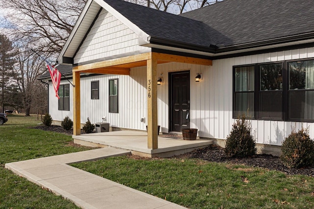 doorway to property with a lawn and a porch